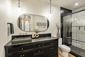 Full bathroom featuring a tile shower and vanity
