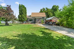 Front view of property with a detached carport and concrete driveway