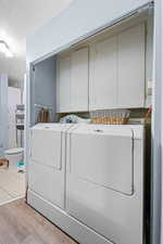 Laundry room featuring cabinet space, separate washer and dryer