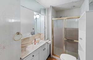 Full bath with vanity and a stall shower