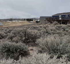 View of yard with stairs and a deck
