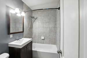 Bathroom with vanity and tub / shower combination