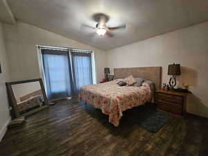 Bedroom featuring wood finished floors, lofted ceiling, and a ceiling fan