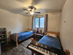 Bedroom featuring wood finished floors and ceiling fan
