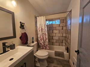 Full bath featuring vanity and shower / bathtub combination with curtain