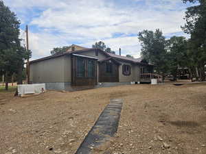 View of front of house with a sunroom and a metal roof