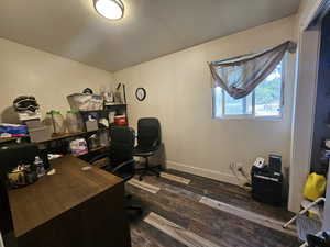 Office space featuring dark wood-style floors and baseboards
