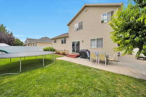 Back of house featuring a trampoline and a patio