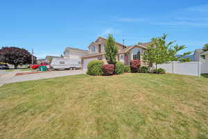 View of front facade with driveway and a garage