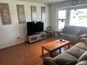 Living area with light wood-style flooring and baseboards