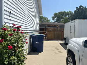 View of side of property with a storage unit and washer / dryer