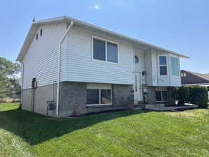 Back of house featuring brick siding