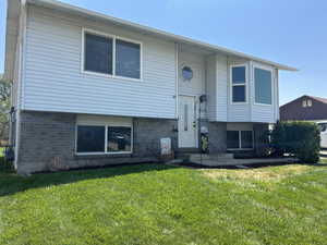 Rear view of house with a lawn