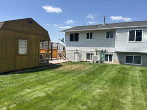 Back of property with a wooden deck
