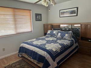 Bedroom with wood finished floors and a ceiling fan
