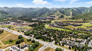 Aerial overview of property's location featuring a water and mountain view