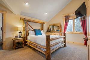 Carpeted bedroom featuring lofted ceiling and recessed lighting