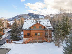 View of front of house featuring covered porch, stairs, and a mountain view