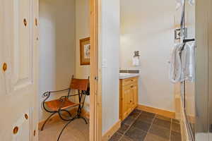 Bathroom featuring vanity and baseboards
