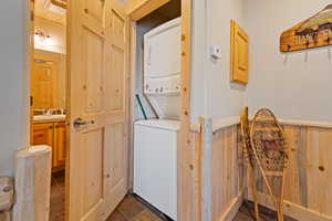 Laundry area featuring stacked washer and clothes dryer