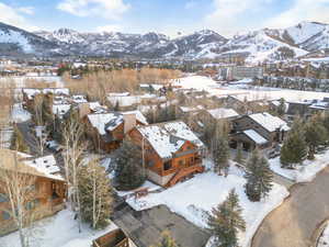 Snowy aerial view with a mountain view and a residential view