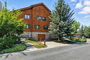 View of property featuring concrete driveway and an attached garage