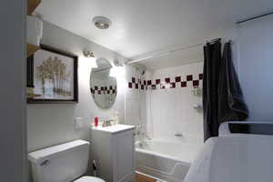 Full bathroom featuring shower / bath combo with shower curtain and vanity
