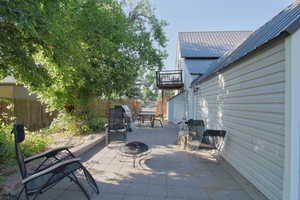 Fenced backyard with a fire pit and a patio