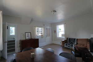 Living room with wood finished floors and stairway