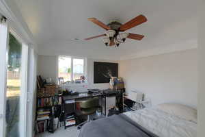 Bedroom with lofted ceiling, carpet flooring, ceiling fan, and an office area