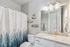 Full bathroom with vanity and curtained shower