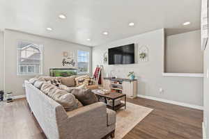 Living area with wood finished floors and recessed lighting