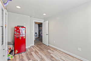 Office space with wood finished floors, a textured ceiling, and recessed lighting