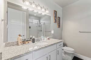 Full en-suite bathroom featuring vanity, bathtub and a stall shower