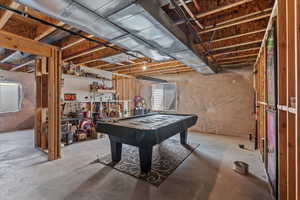 Recreation room with concrete flooring and pool table