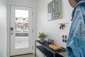 Doorway to outside featuring light tile patterned floors