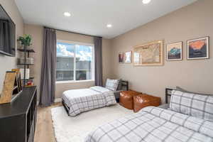 Bedroom with light wood finished floors and recessed lighting