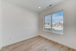 Unfurnished room featuring light wood finished floors and recessed lighting