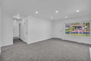 Empty room with carpet floors and recessed lighting