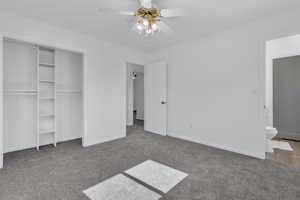 Unfurnished bedroom with carpet floors, a ceiling fan, and a closet
