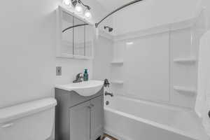 Bathroom featuring shower / washtub combination and vanity