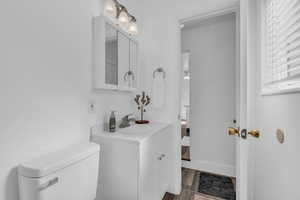 Bathroom with vanity and wood finished floors
