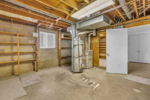 Unfinished basement featuring water heater