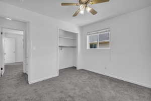 Unfurnished bedroom featuring carpet floors, a closet, and a ceiling fan