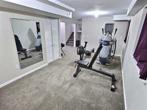 Workout room with carpet and baseboards