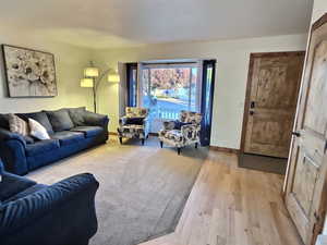 Living room with light wood-type flooring and baseboards
