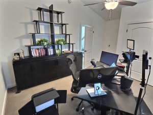 Carpeted office with ceiling fan and vaulted ceiling