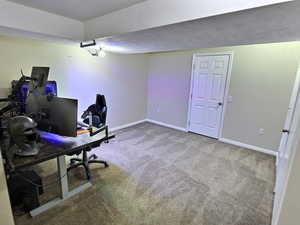 Home office with carpet floors and baseboards