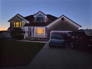View of front of property with driveway and a garage