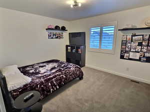 Carpeted bedroom with baseboards